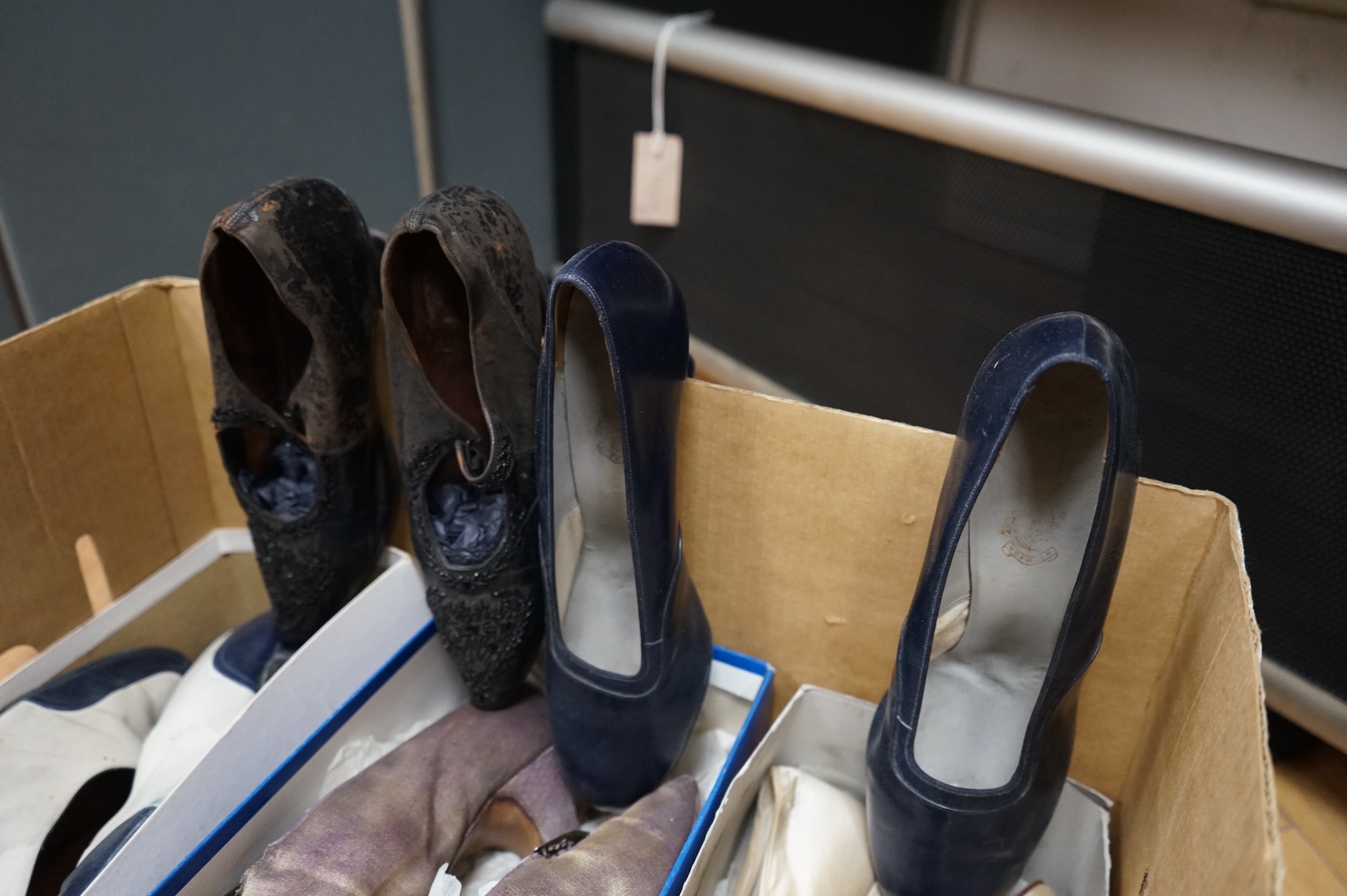 Five pairs of ladies shoes from 1900-1940's; a pair black leather and jet shoes, a pair of cream silk wedding shoes, lilac evening shoes, a pair of two tone leather shoes and a similar navy pair
